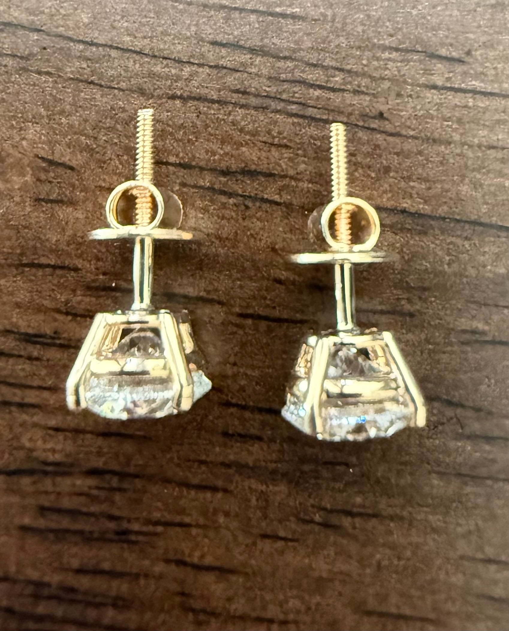 3 Total Carat Weight Round Diamond Earrings, E/VS1. Set On 4 Prong 14K Yellow Gold Setting.