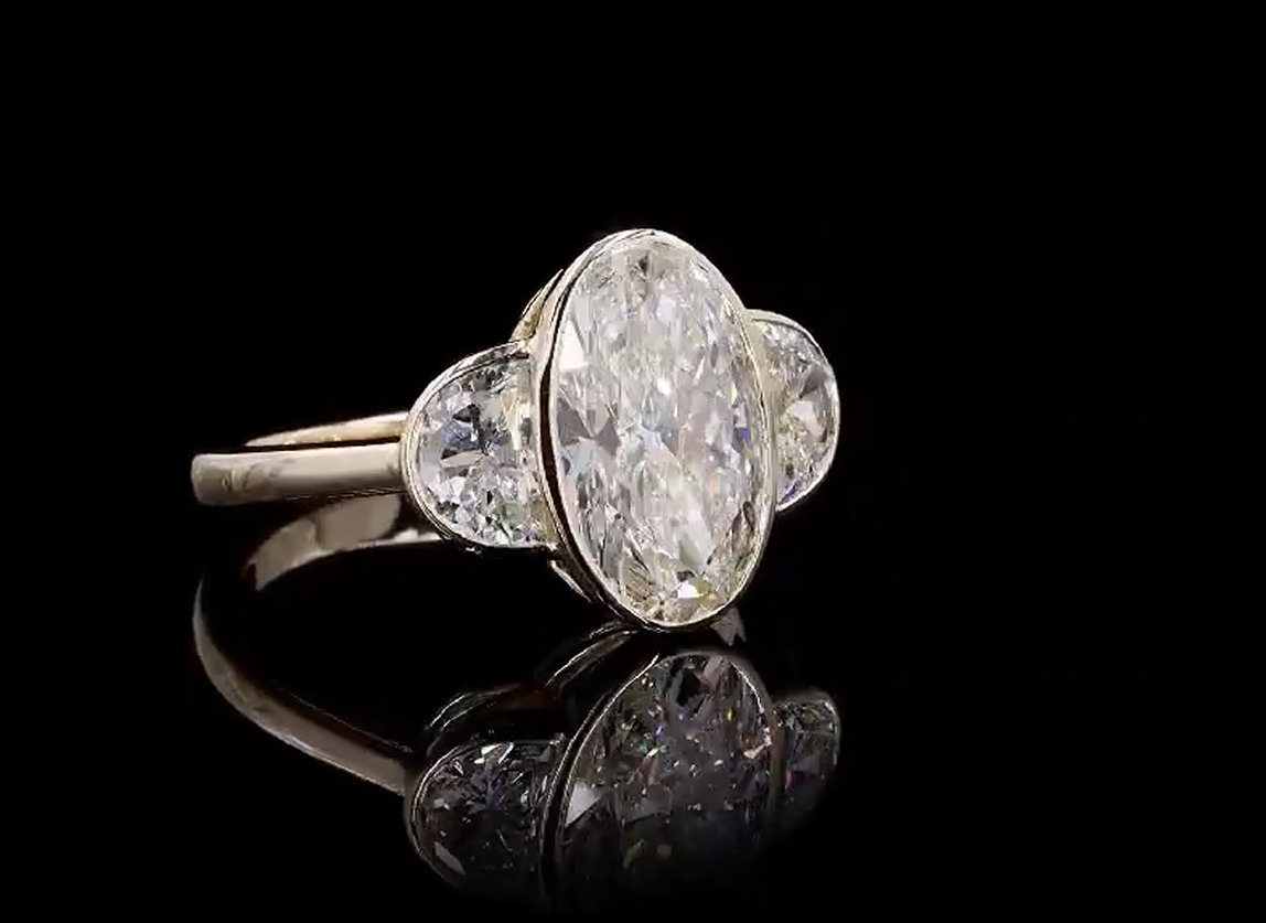 3 carat elongated oval e vvs2 center stone with e vvs2 half moon stones on side