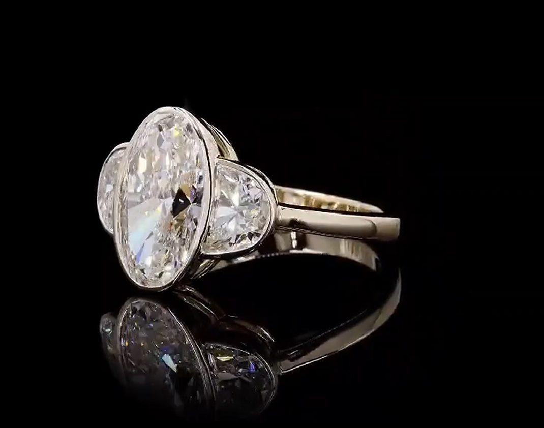3 carat elongated oval e vvs2 center stone with e vvs2 half moon stones on side