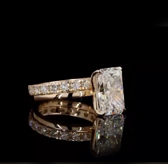 4 carat e vs1 radiant center stone on a 14k yellow gold solitaire band   Paired with a 14k yellow gold 2 carat eternity band