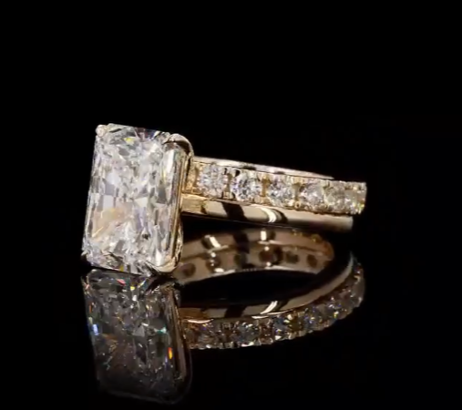 4 carat e vs1 radiant center stone on a 14k yellow gold solitaire band   Paired with a 14k yellow gold 2 carat eternity band