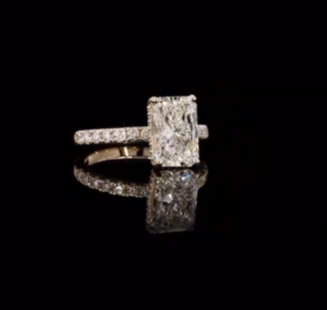 3 carat e vvs2 radiant on a 14k yellow gold half carat diamond band with diamond hidden halo