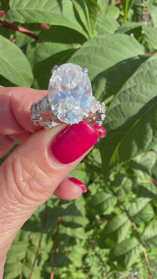 7.00 Carat Oval Diamond RIng. Set On 5 Carat Round & Oval Diamonds, 14K White Gold Band.